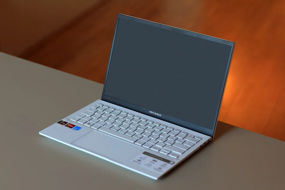 A website wireframe on a macbook screen on an office desk.